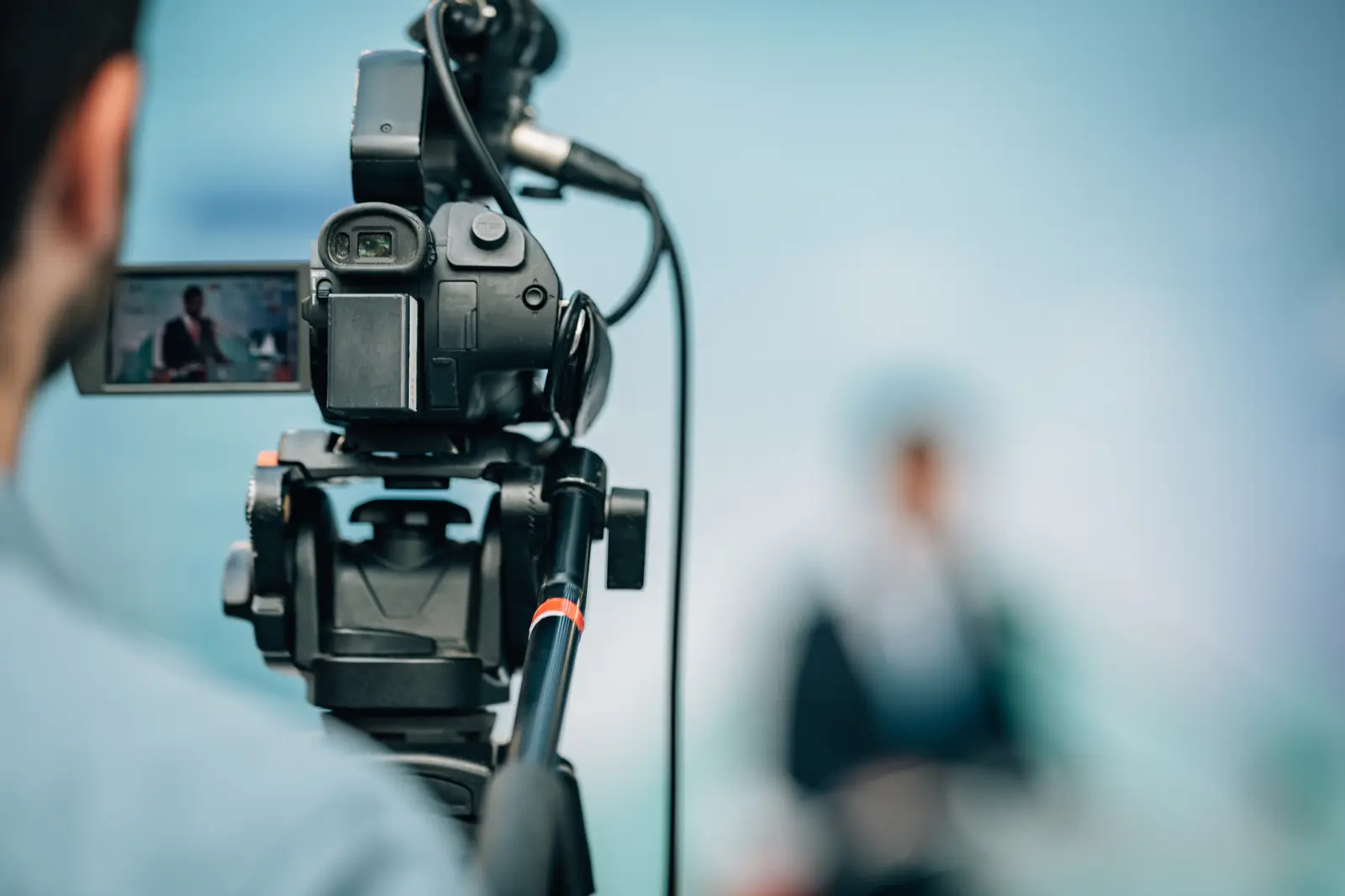 Television camera in studio aimed at an interview subject